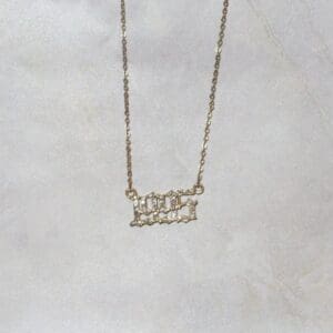 A gold necklace with a number one on it