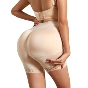 A woman in beige underwear is standing with her back to the camera.