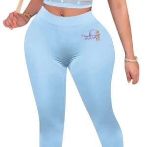A woman in blue pants and top holding a baseball bat.